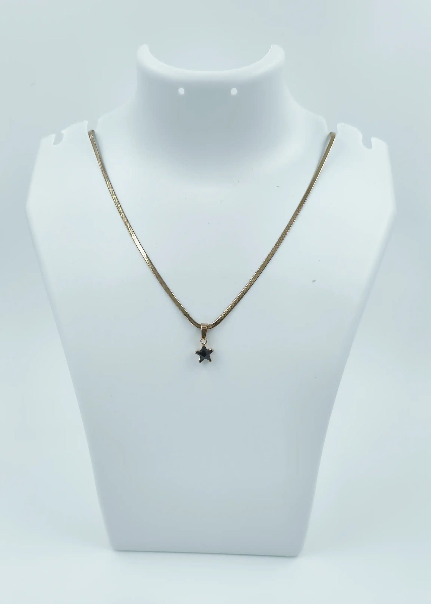 Necklace with a star pendant on a mannequin bust against a white background