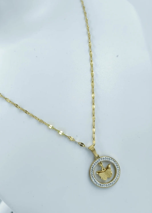 Gold necklace with a round pendant on a white background