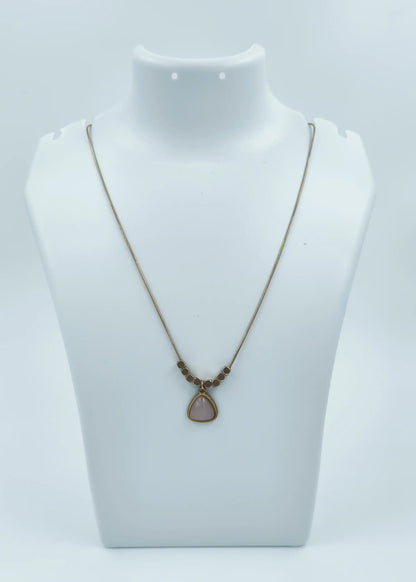 Necklace with a pendant on a mannequin bust against a white background