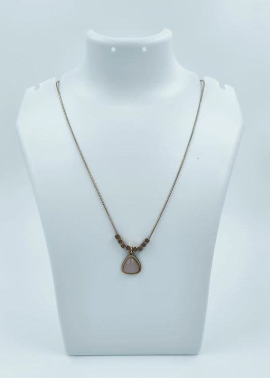 Necklace with a pendant on a mannequin bust against a white background
