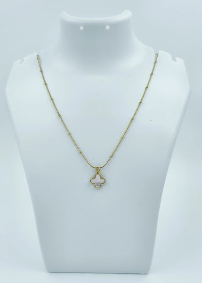 Gold necklace on a white mannequin bust against a white background