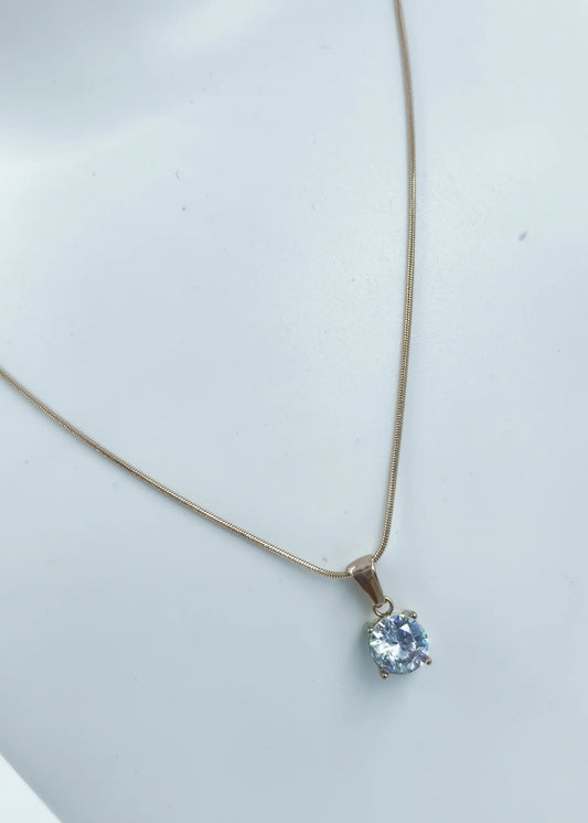 Necklace with a pendant featuring a blue gemstone on a light gray background