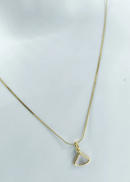 Gold necklace with a triangular pendant on a white background
